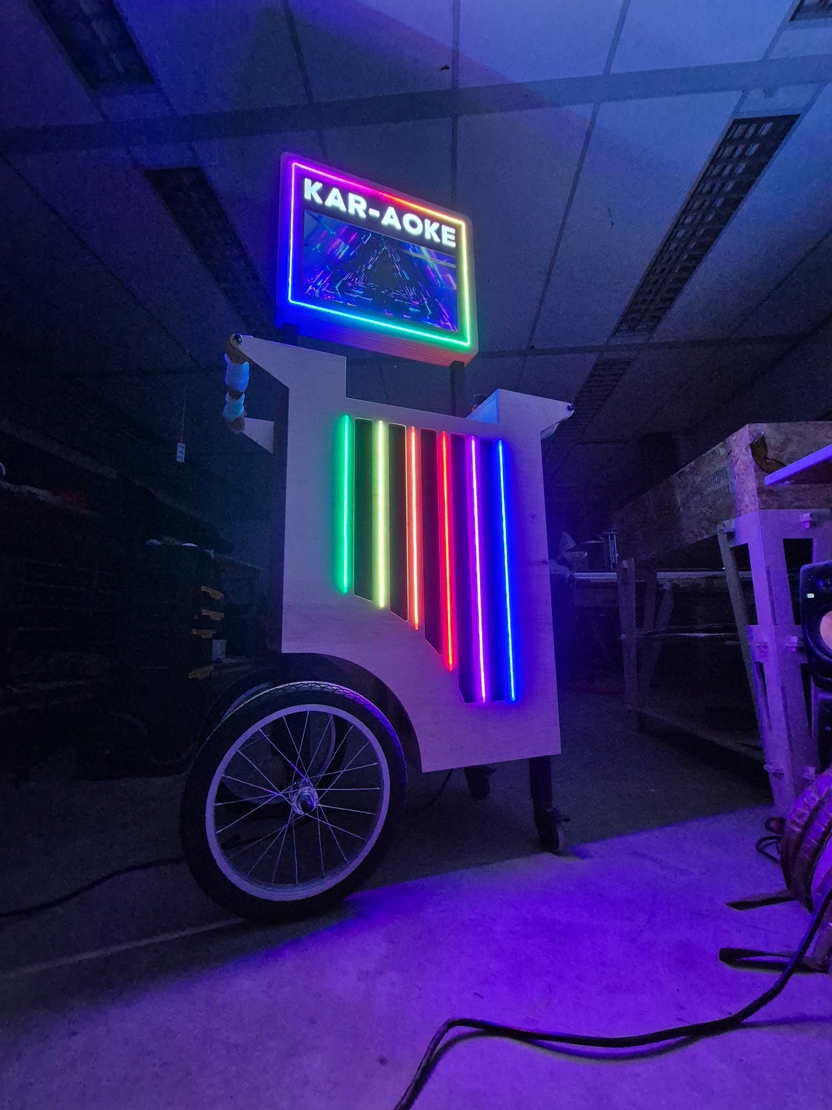Front three-quarter view of the Kar-aoke cart and lyric display