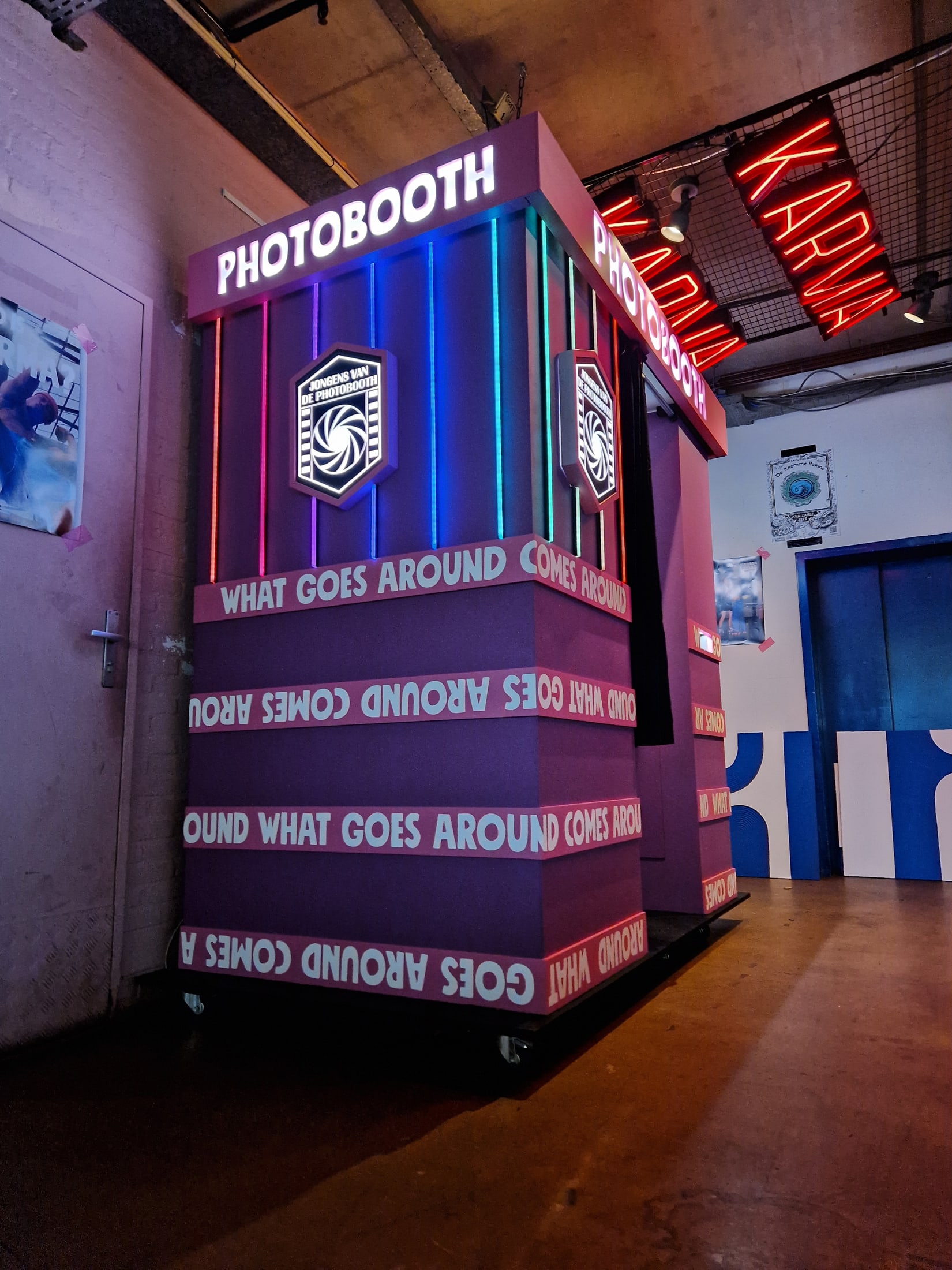 Karma Kebab Photobooth beneath the restaurant's red neon signage