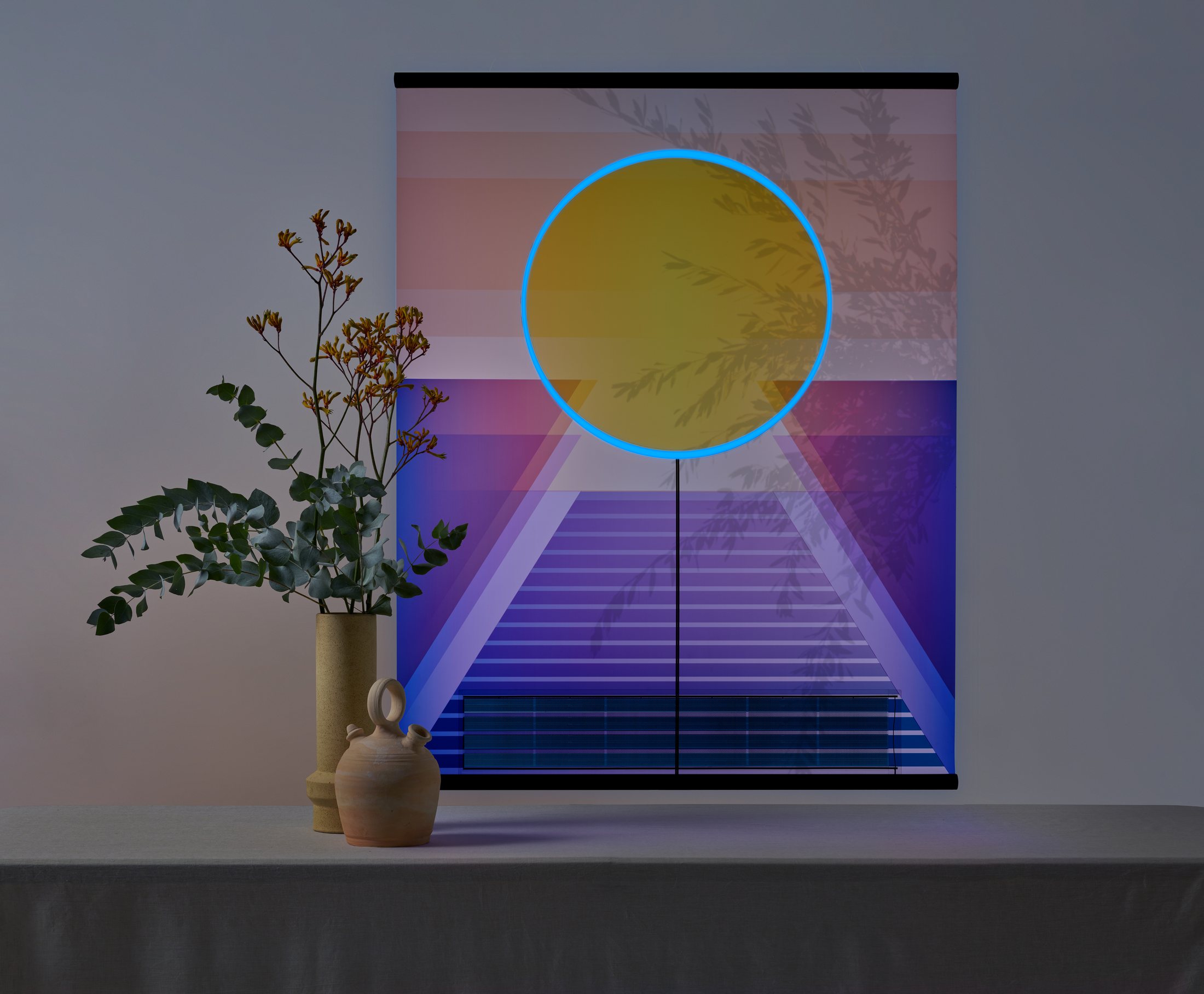 RA solar tapestry glowing blue in a darkened interior