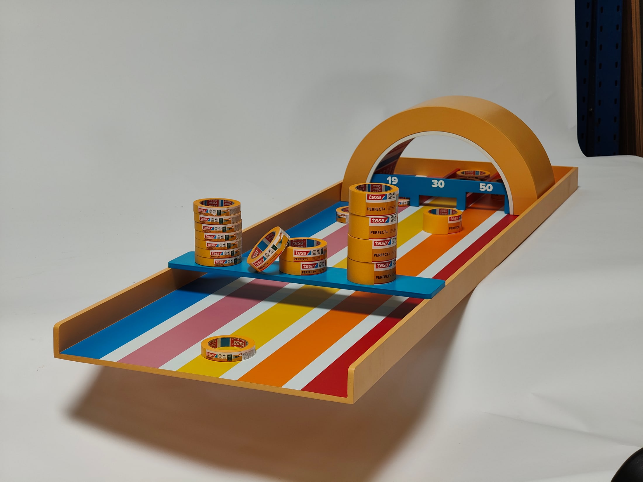 Complete Tesa shuffleboard with tape-roll pieces arranged for play