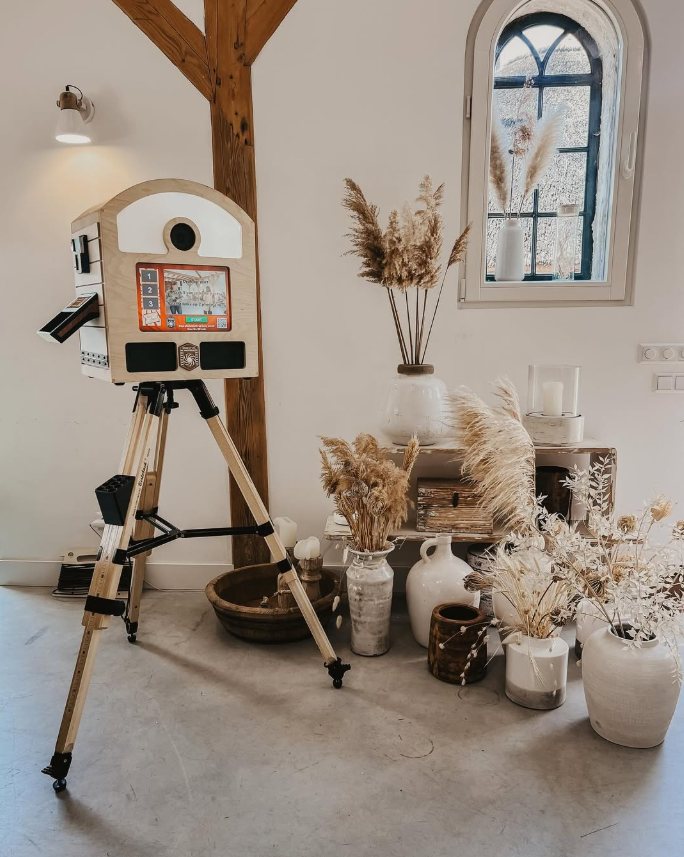 Full To Go Photobooth on its wooden tripod in a styled interior