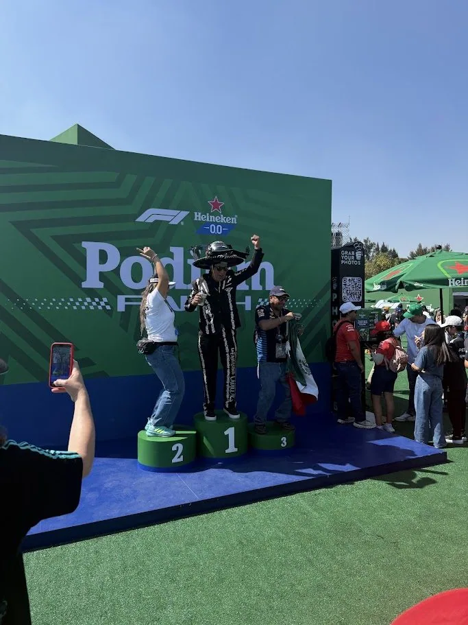 Fans celebrating on the numbered Heineken podium during the Mexico Grand Prix