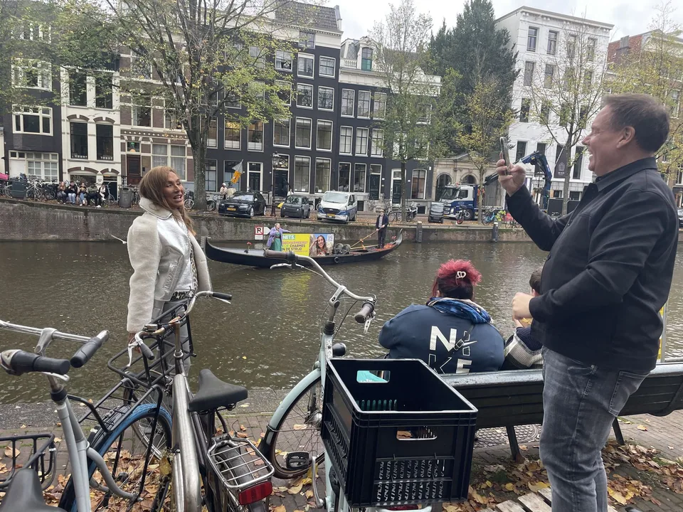 Canalside production view with the NET5 gondola moving through Amsterdam in the background