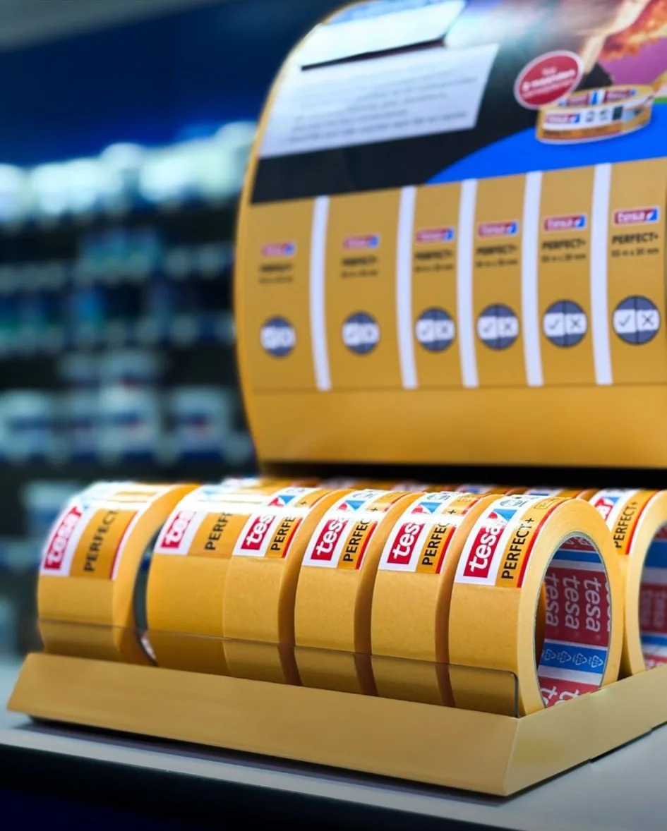 Row of tesa Perfect tape rolls arranged in the finished dispenser