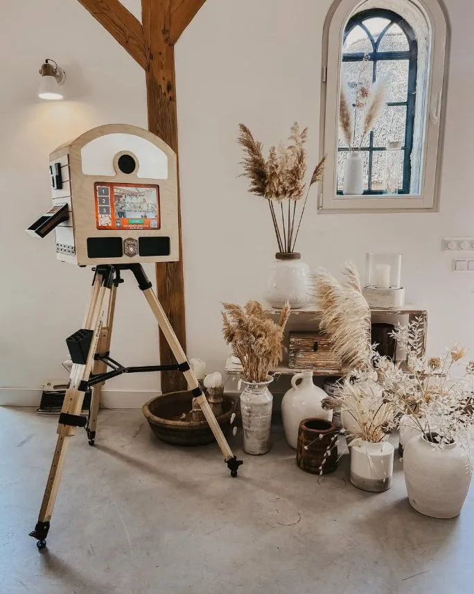 Full To Go Photobooth on its wooden tripod in a styled interior